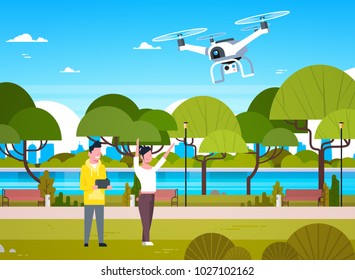 Young People Playing With Drone Copter In Park Man And Woman Using Remote Controller For Quadrocopter Flat Vector Illustration