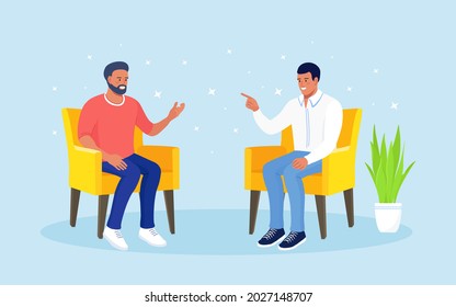 Young people sitting in armchair and talking. Men speaking,  colleagues communicating. Discussion of friends. Teamwork. Social networks, dialog and conversation. People asking, answering questions