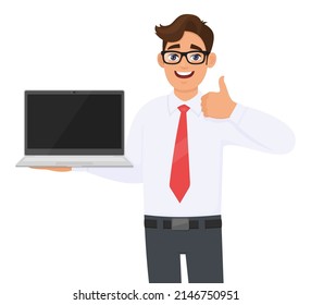 Young Person Showing Laptop And Gesturing Thumbs Up Or Like Symbol. Business Man Carrying Computer. Male Character Holding Digital Technology Device. Modern Lifestyle Illustration In Vector Cartoon.