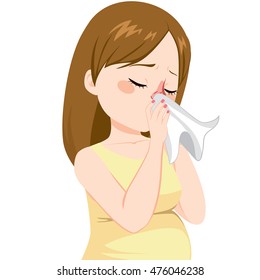 Young pregnant woman with flu sneezing on tissue