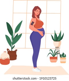 Young pregnant woman  in sportswear doing yoga at home. Prenatal sport exercise, aerobic activity. Trendy scandinavian hygge interior, living room. Happy motherhood healthy lifestyle