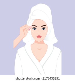 Young pretty girl plucks eyebrows with tweezers in bathrobe skincare make up beauty concept, Facial hair removal. Beautiful young woman shaving her face by razor at home