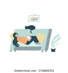 A young pretty woman, girl student lying in a cozy room and reading a book. There are a cat, indoor flower, an abstract picture on the wall. Reading person consept