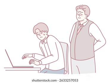 Um jovem profissional está concentrado enquanto digita com diligência em seu notebook enquanto é supervisionado por um colega sênior