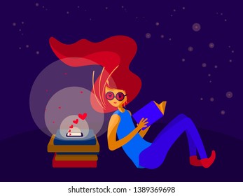 A young red-haired woman in glasses sitting in the night, holding a book in the hands, looking at the glowing smartphone screen and receiving romantic messages or likes.