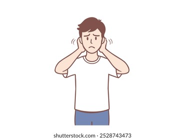 Young sad irritated man cartoon character standing covering his ears with fingers with no sounds inside. Hand drawn style vector design illustrations.