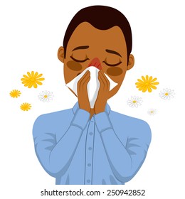 Young sick African American man ill suffering spring allergy using white tissue on nose