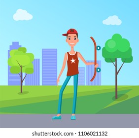 Young skateboarder holds skateboard on background of buildings at park. Go skateboarding day male teenager and longboard, skyscrapers in backdrop.