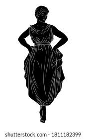 A young slender woman in a dress is standing on her toes and dancing.