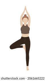 Young slim woman doing yoga exercise. Vrikshasana, tree pose