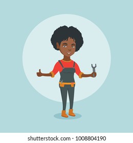 Young smiling african-american female repairman standing with a spanner in hand and giving thumb up. Repairman in overalls holding a spanner. Vector cartoon illustration. Square layout.