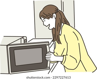 Young smiling asian woman using microwave oven
