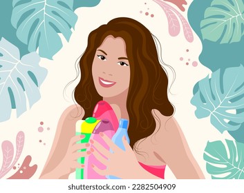 Young smiling brunette girl with cosmetics in her hands on a light background with tropical leaves