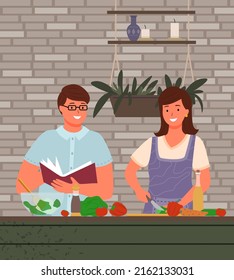 Young smiling couple in aprons making salad together, preparing vegetarian food. Culinary concept with young family make food at home, fresh vegetables, bottle of oil, groceries and kitchenware