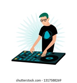 Young smiling male hipster DJ in glasses playing music at console with vinyl record