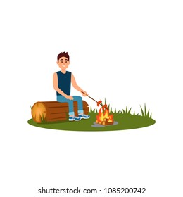 Young smiling man sitting on log and cooking sausages on campfire. Recreation at nature. Outdoor activity. Flat vector design