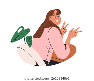 Young smiling woman sitting at desk, v sign. Happy girl, relaxed female character at office table gesturing with hand, fun posing at workplace. Flat vector illustration isolated on white background