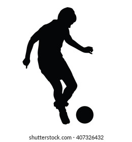 Young Soccer Player Passes The Ball Silhouette, Kid Plays Soccer Or Football. Front View. Football Player Is Taking Off With The Ball