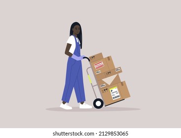 A young storage worker in denim overalls rolling a cart loaded with cardboard boxes, delivery service, cargo shipment