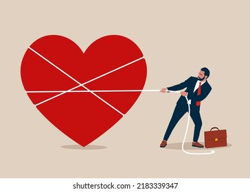 Young strong businessman pulling a heart with a rope, love and achievement. Saint Valentine's Day.
