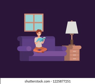 young student sitting reading book in livingroom
