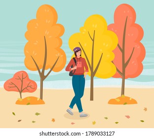 Young stylish girl walking in autumn park near organge and yellow trees. Pretty woman wear hoodie and jeans. Leisure activities outdoors. Spend free time with nature. Cartoon character with backpack