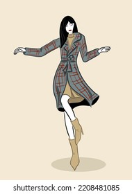 Young stylish woman in a coat dancing and posing.