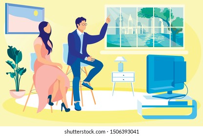 Young Stylish Woman and Man, Dressed in Smart Business Suit, Sitting on Chairs in Front Tv Set, Watching Program and Discussing It. Light Spacious Room with Big Window and Skyscrapers Outside.