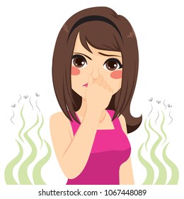 Young teenager girl pinching her nose bad stinking bad smell concept