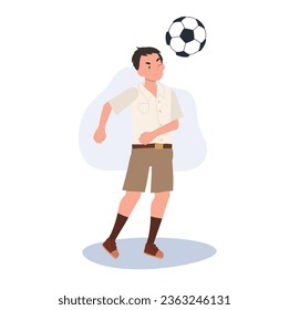 Joven estudiante tailandés pateando una bola después de clases. Joven estudiante tailandés jugando al fútbol después de la escuela