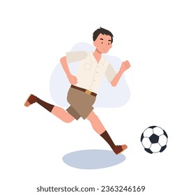 Joven estudiante tailandés pateando una bola después de clases. Joven estudiante tailandés jugando al fútbol después de la escuela