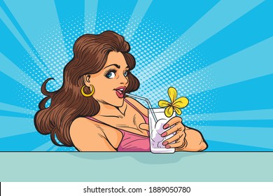 Young trendy blonde woman with a glass of refreshing lemonade posing in the swimming pool
