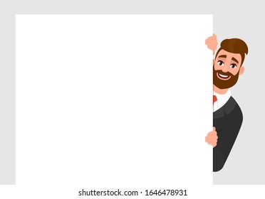 Young trendy businessman standing behind the white blank poster. Hipster person holding empty banner. Male presenting signboard/billboard. Mock up template. Cartoon illustration design in vector style