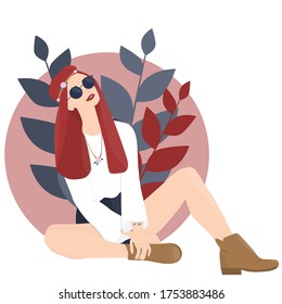 Young trendy smiling red-haired hippie girl with colorful leaves on background