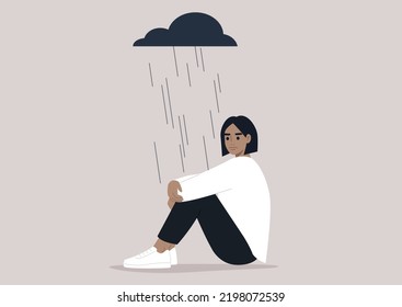 A young upset character hugging their knees, a black rain cloud hovering above them