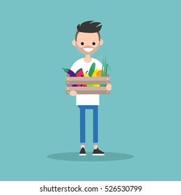 Young vegetarian bearded man holding a crate full of fruits and vegetables / editable flat vector illustration, clip art