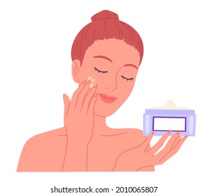 Young woman applying cream to her face