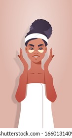 young woman applying eye patches dressed in towel african american girl cleaning and care her face skincare spa facial treatment concept portrait vertical vector illustration