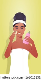 young woman applying foundation cream dressed in towel african american girl cleaning and care her face skincare spa facial treatment concept portrait vertical vector illustration