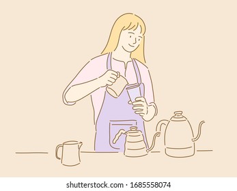 A young woman barista is wearing an apron and making coffee.