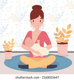 Young woman breastfeeding her baby .Lotus position.Breastfeeding concept.Motherhood.