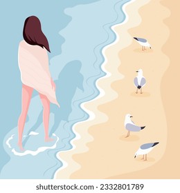 Young woman with brown hair walking along sandy beach alone. Calm summer landscape with seagulls on the shore.