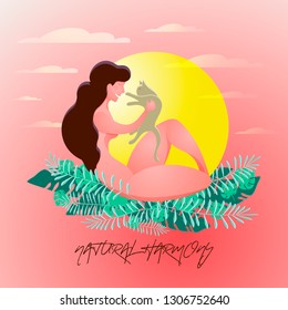 A young woman with a cat in her hands on a background of tropical leaves. The concept of harmony with nature, relaxation, rest, emotional balance.