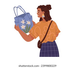 Young woman chooses bag in store. Girl holds summer bag in her hands standing isolated on white. Clothing care concept, womens wardrobe items and accessories. Ladys garment, elegance handbag