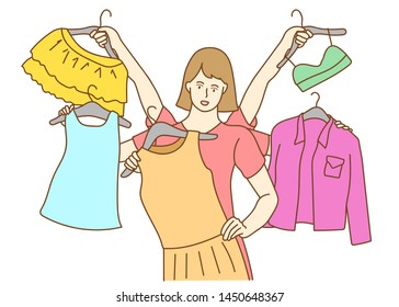 Young woman choosing clothes, the woman trying on new clothes