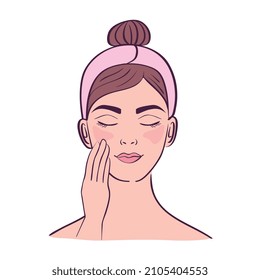 young woman cleaning her face