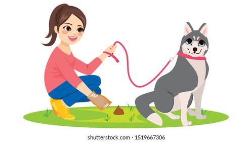 Young woman cleaning her husky pet dog poo