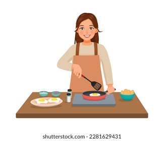 Young woman cooking fried egg with frying pan in the kitchen