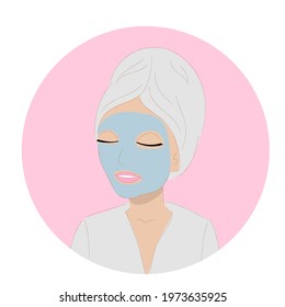 Young woman in cosmetic mask with a towel on her head 