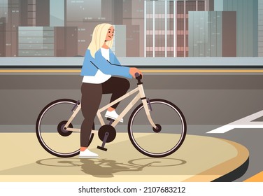 young woman cyclist waiting for green traffic light to cross road on crosswalk girl riding bicycle healthy lifestyle